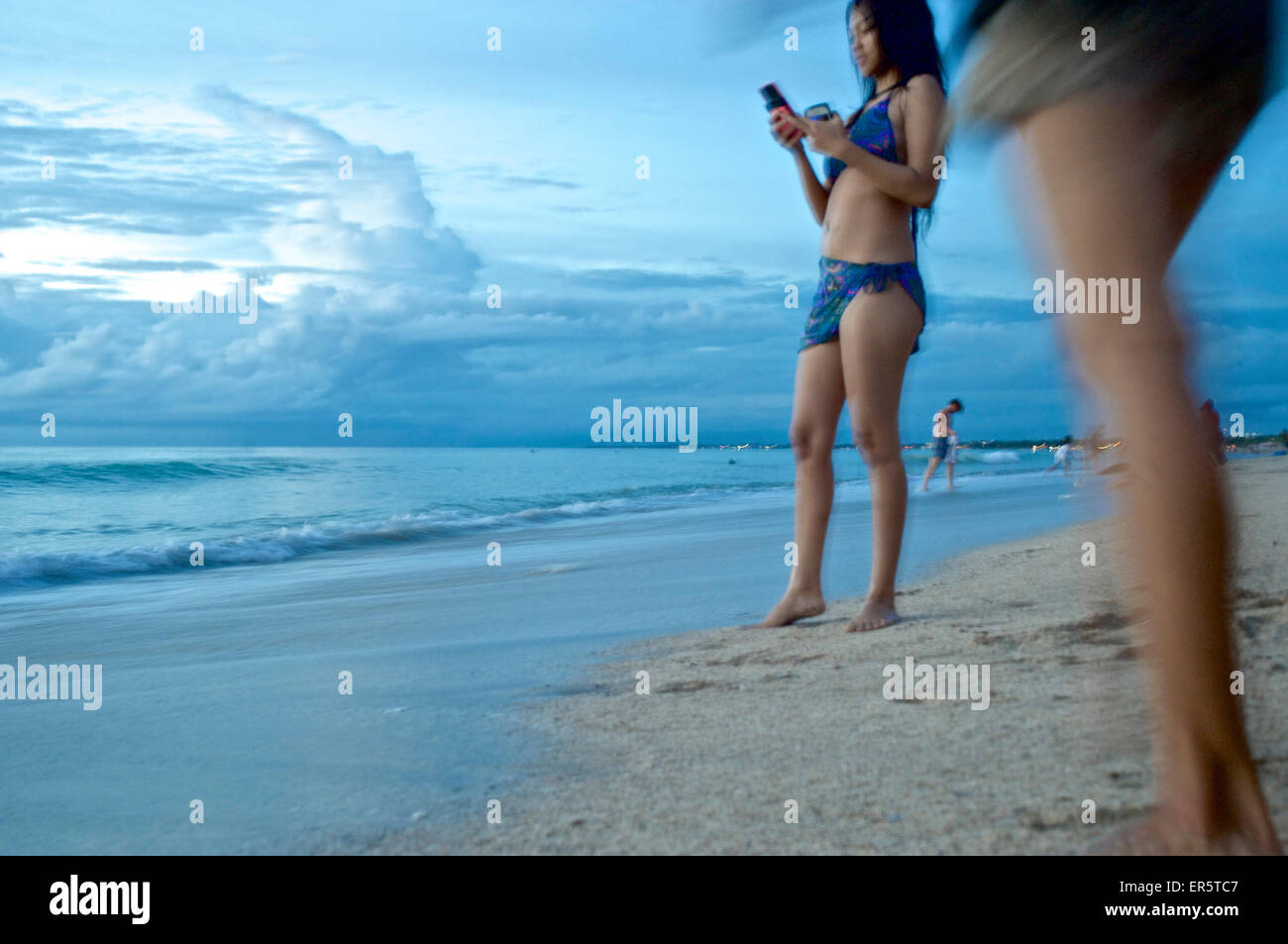 Chinese female tourists in the evening on the beach, Kuta, Bali, Indonesia Stock Photo