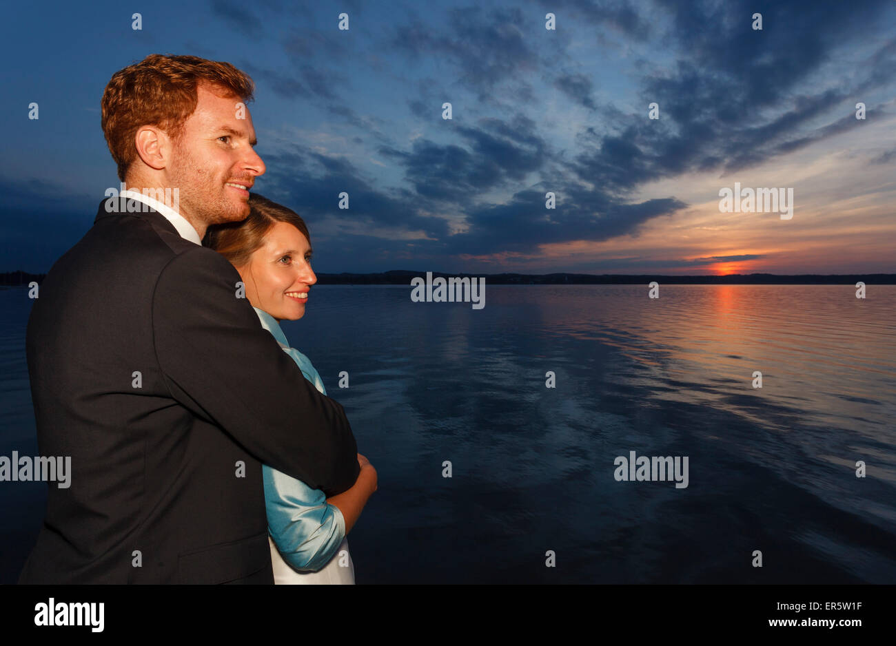 bridal couple is looking in sunset, Starnberger See, Bavaria, Germany Stock Photo