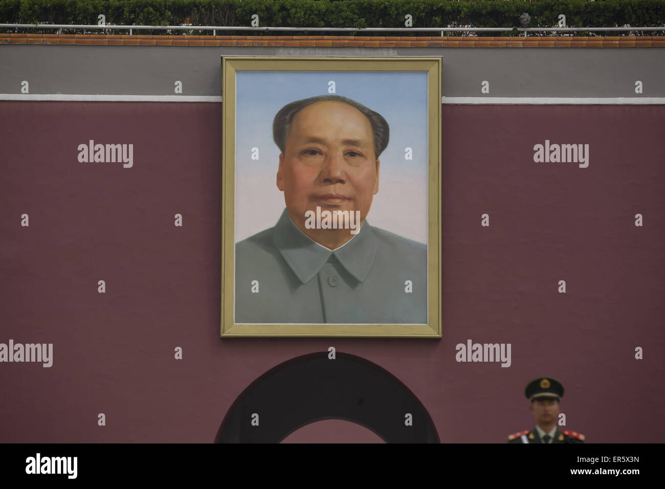 The armed police stand in front the portrait of Chairman Mao at ...