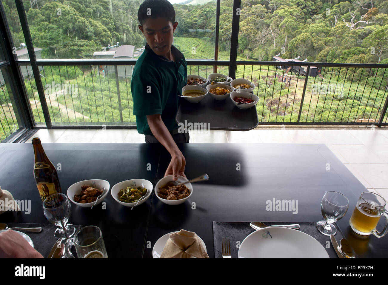 Waiter serving Sri Lankan currys, restaurant with jungle view, Sinharaja Forest Reserve Lodge in the Sinharaja Mountains, South Stock Photo