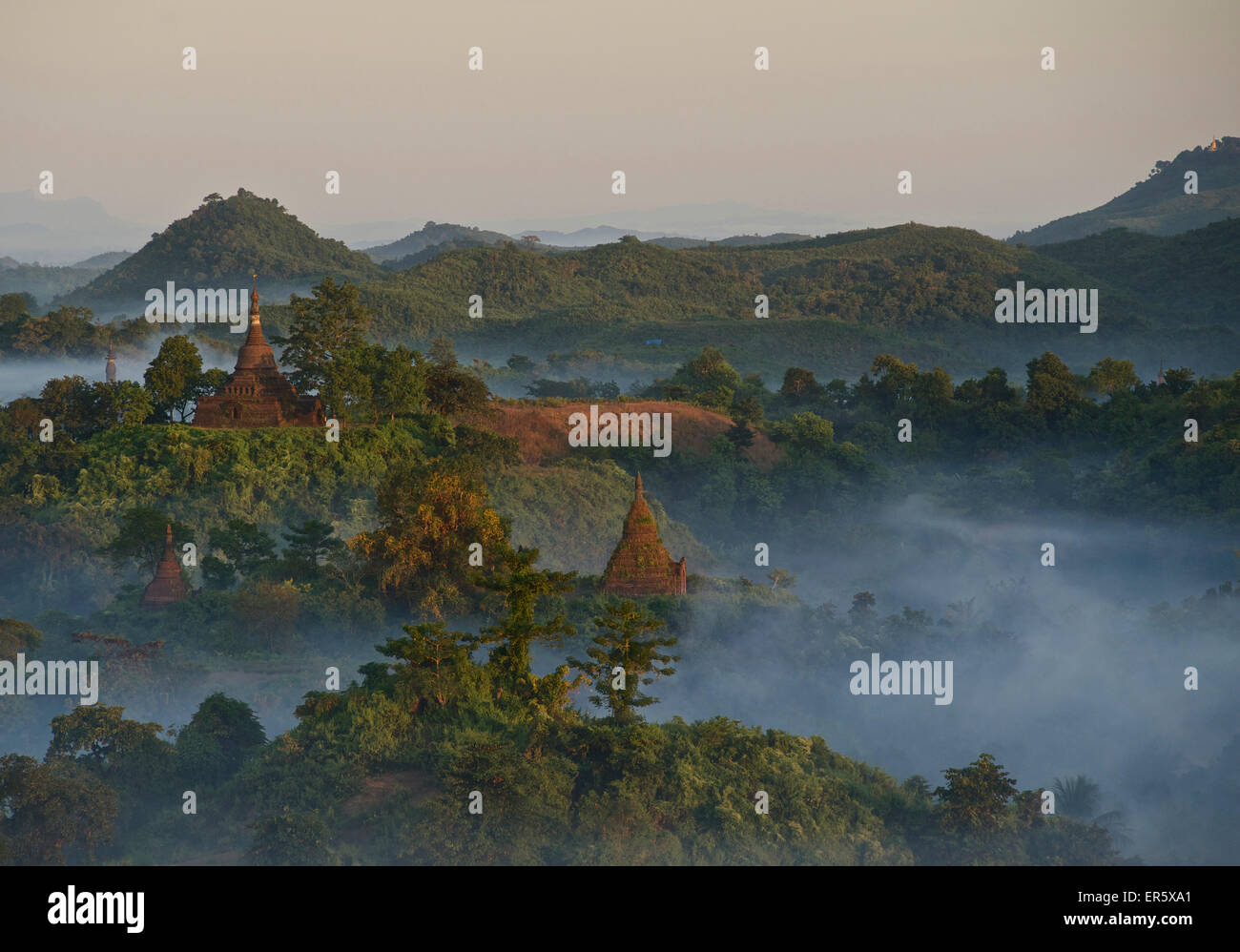 View over the hills and pagodas in the evening mist at Mrauk U, Myohaung north of Sittwe, Akyab, Rakhine State, Arakan, Myanmar, Stock Photo