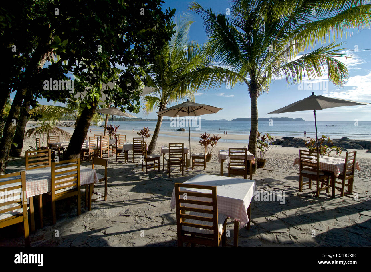 Dining tables under palm trees, Ngapali, most famous beach resort in