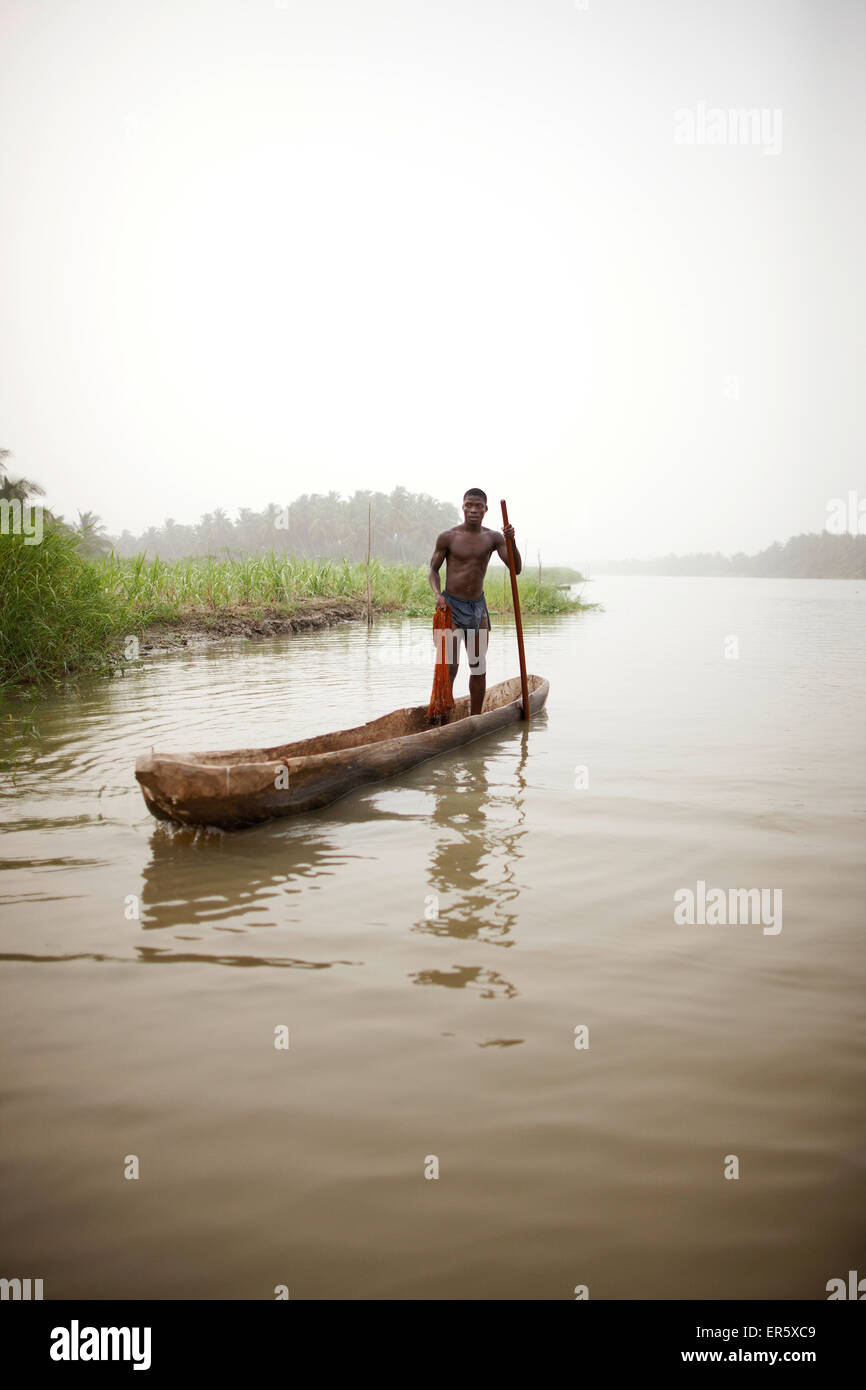 Man in a logboat fishing on Mono river, Agbanakin, near Grand-Popo, Mono  Department, Benin Stock Photo - Alamy