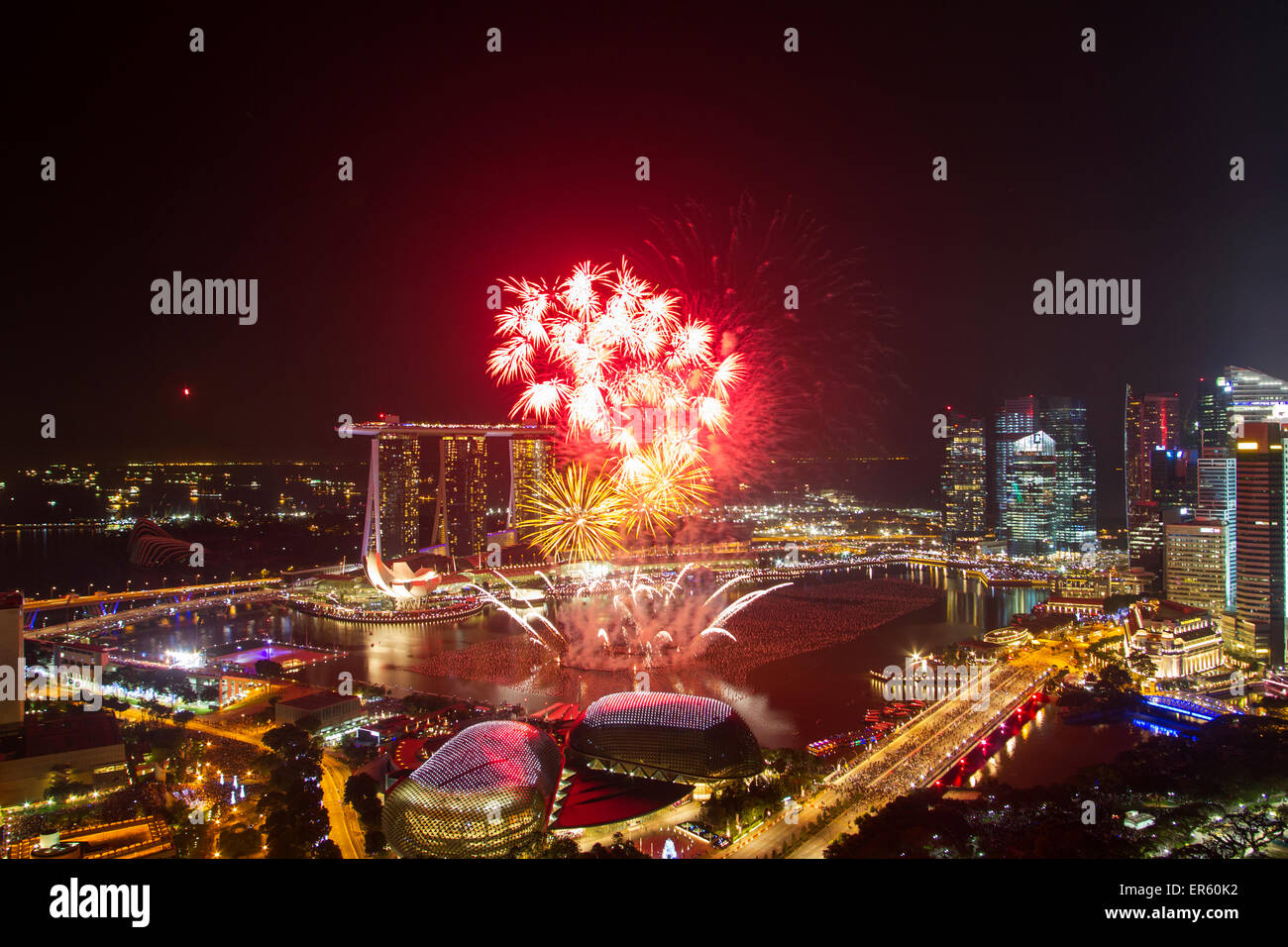 The Singapore skyline is illuminated by fireworks for New year celebrations in the Marina Bay Central Business District (CBD) Stock Photo