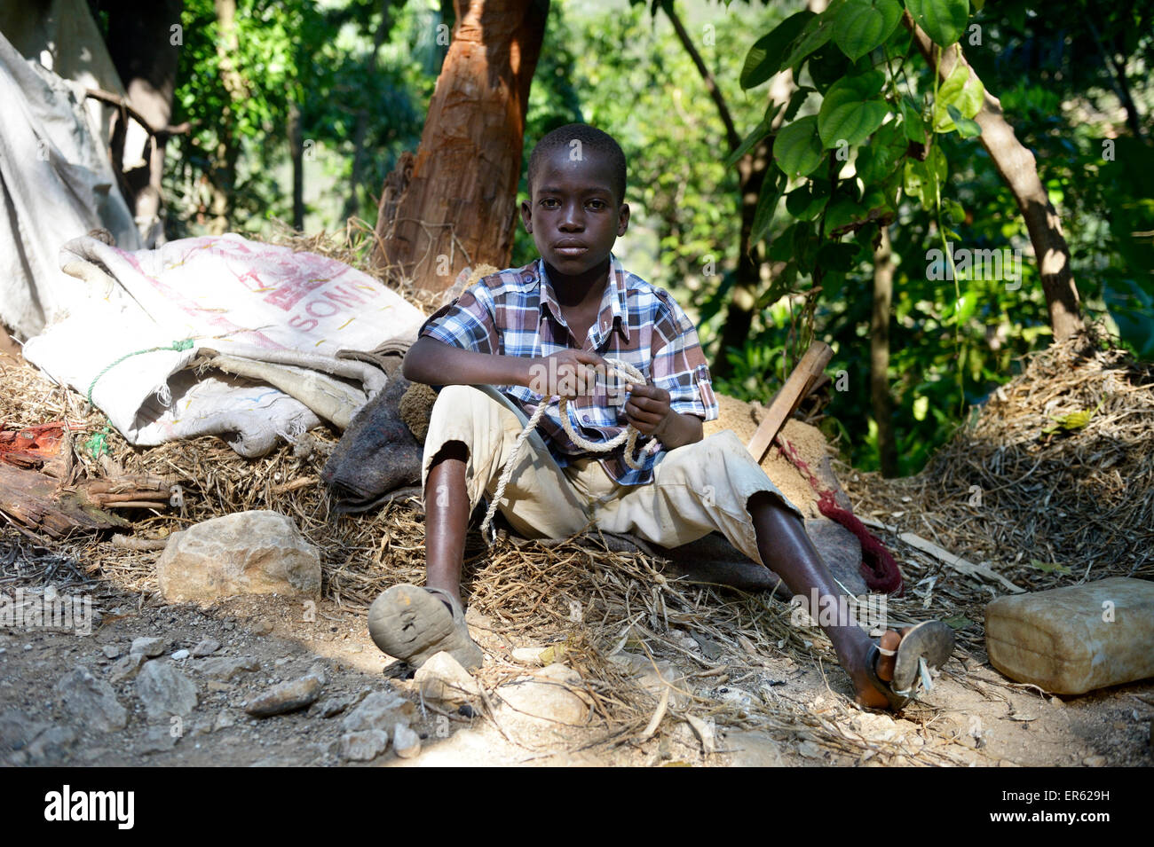 Boy, 9 years, sitting on the ground, Riviere Froide, Ouest Department