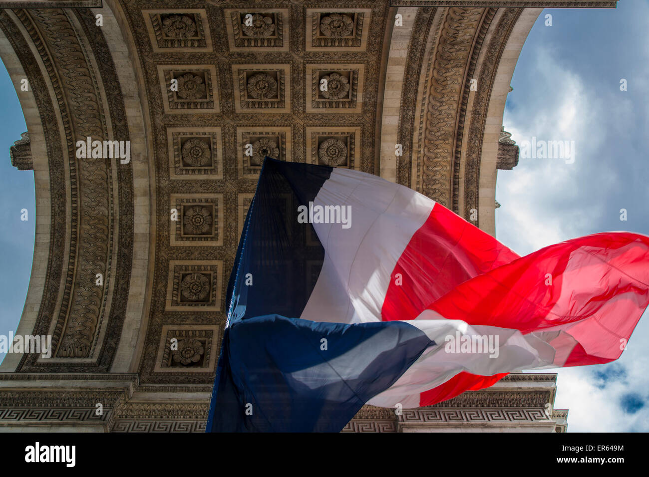 Tri-Color French flag flying below Arc de Triomphe, Paris, France Stock Photo