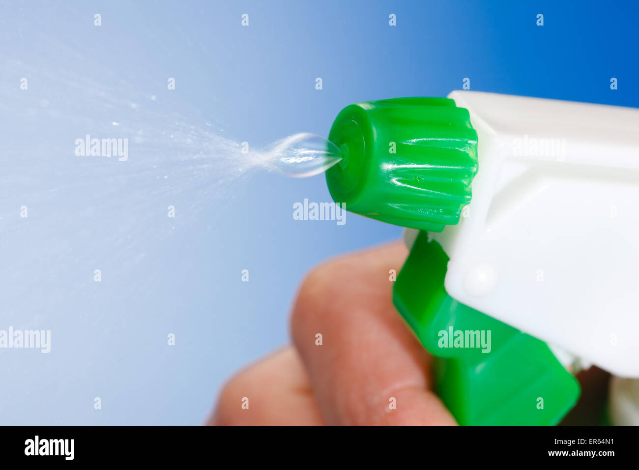 Macro of water being sprayed from green bottle Stock Photo Alamy