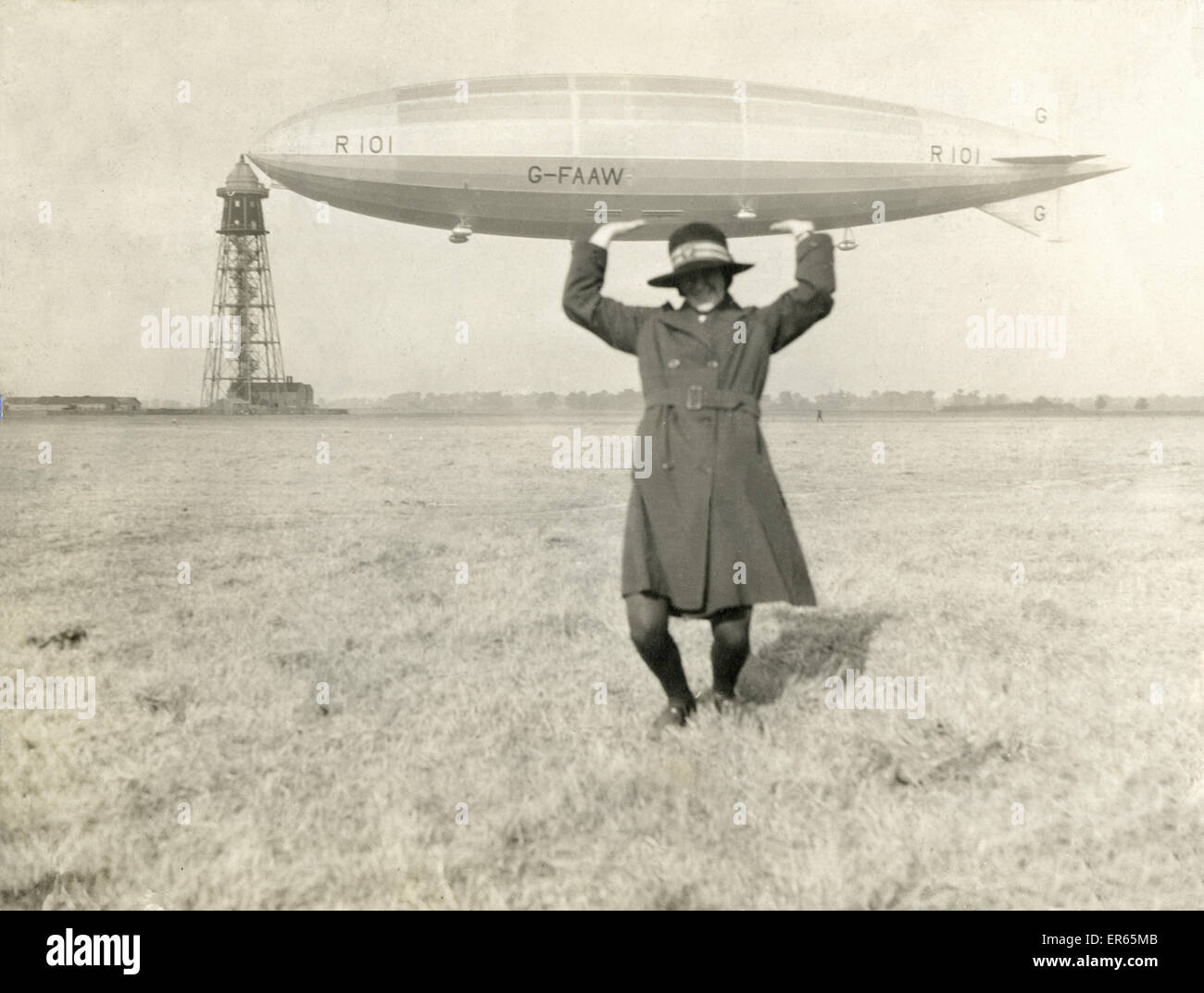 A member of the WAAC - the Women's Army Auxiliary Corp - 'holds up' the R101 Airship, riding at her home mast at Cardington, Bedford. R101 was a British rigid airship completed in 1929 as part of the Imperial Airship Scheme. After initial flights and two Stock Photo