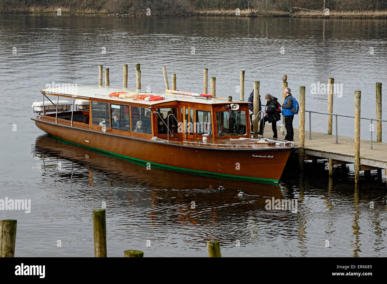 Keswick Landing Stage with lake passenger boat moored with passengers boarding Stock Photo