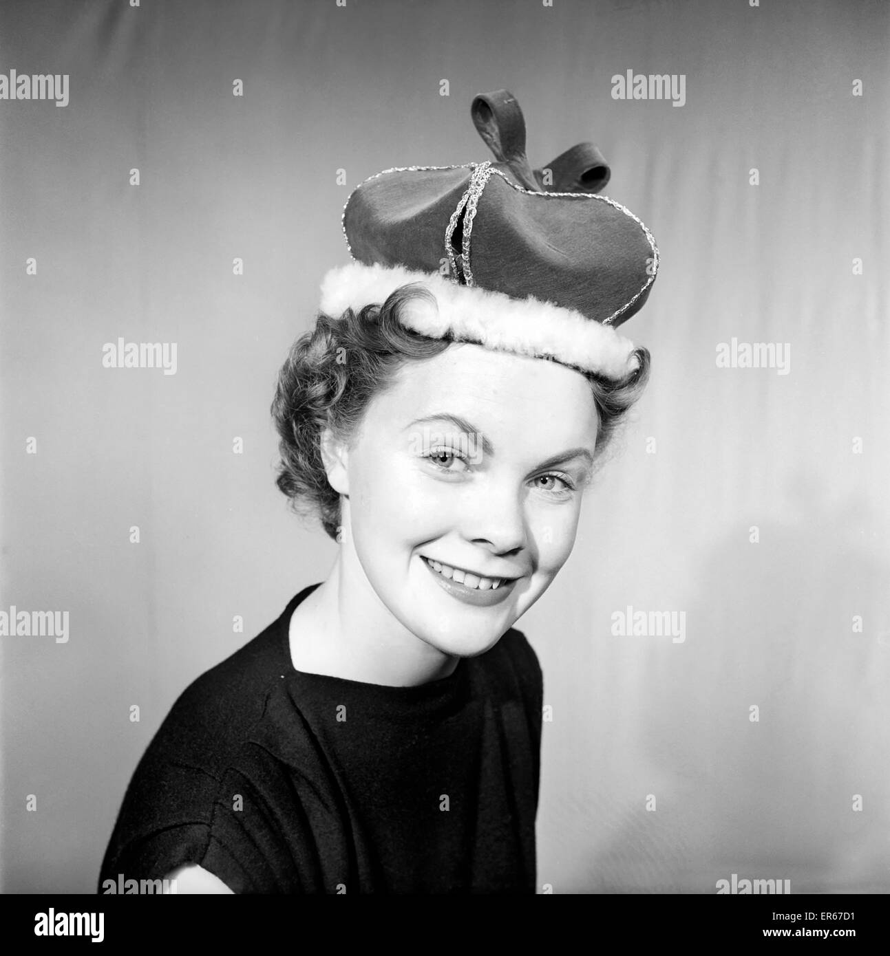 Clothing: Fashion: Hats: Woman wearing crown hat. 1958 B118-001 Stock Photo