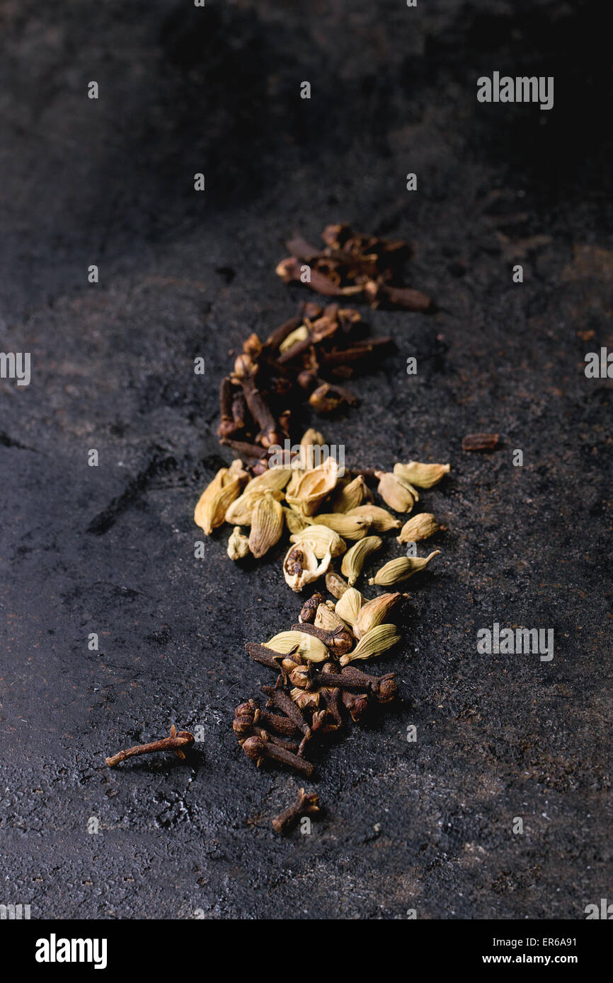 Cardamom seeds and cloves over black background Stock Photo Alamy