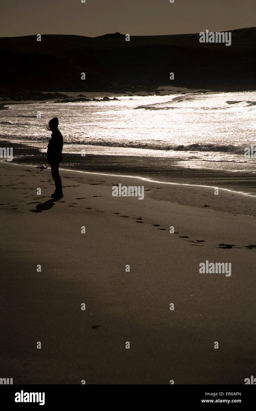 Woman silhouetted on Hosta beach, North Uist, The Outer Hebrides ...