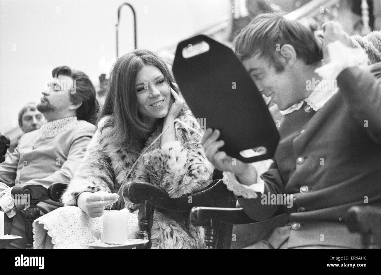 A final flick of the comb for Michael Jayston (Demetrius) and a quick joke with Diana Rigg (Helena) on the set of Peter Hall's  film of 'A Midsummer Night's Dream'  at Compton Verney Estate. 1st November 1967 Stock Photo