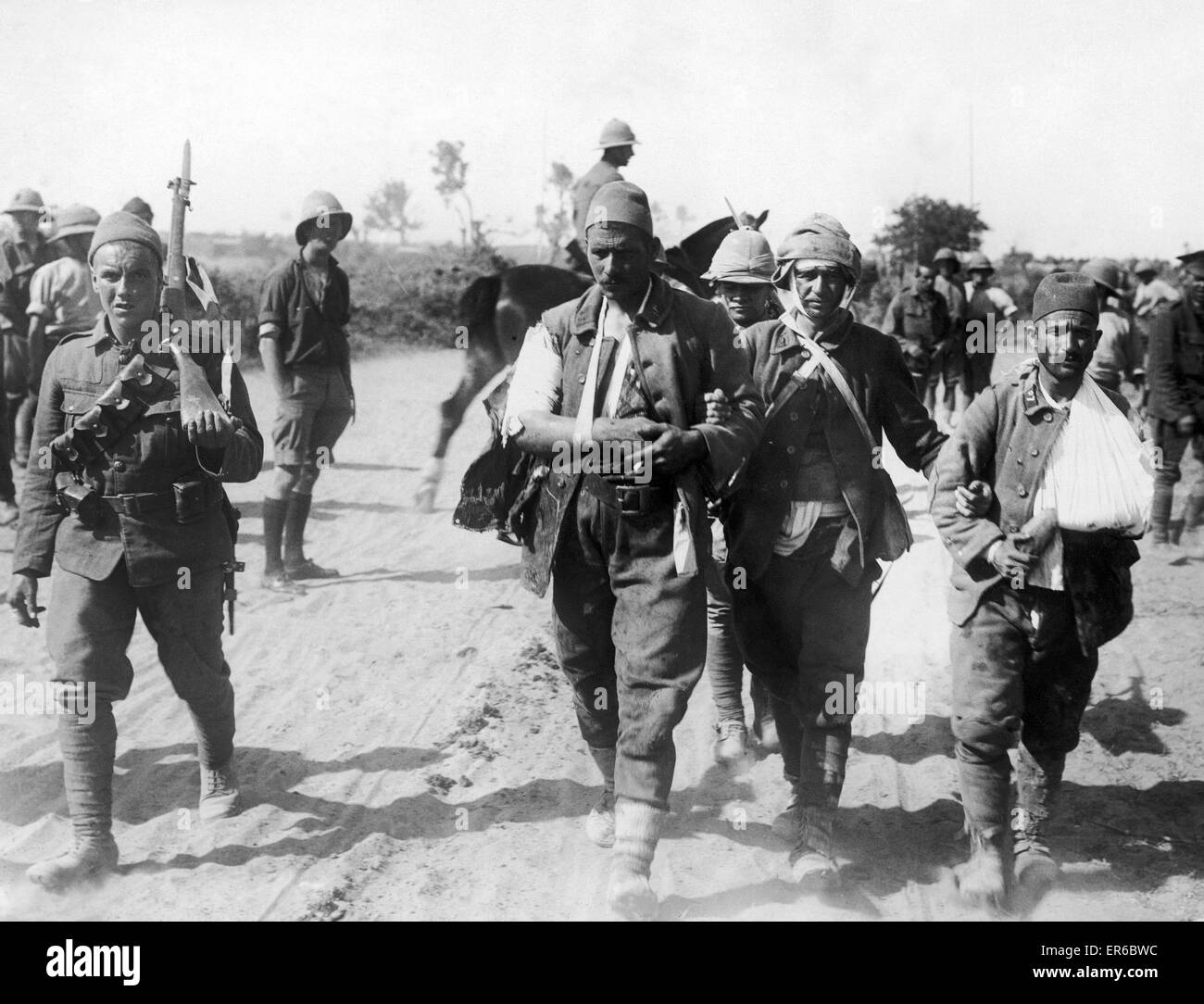 Three wounded Turkisk prisoners being brought into the British lines close to W Beach, Cape Helles, Gallipoli. 6th August 1915 Stock Photo