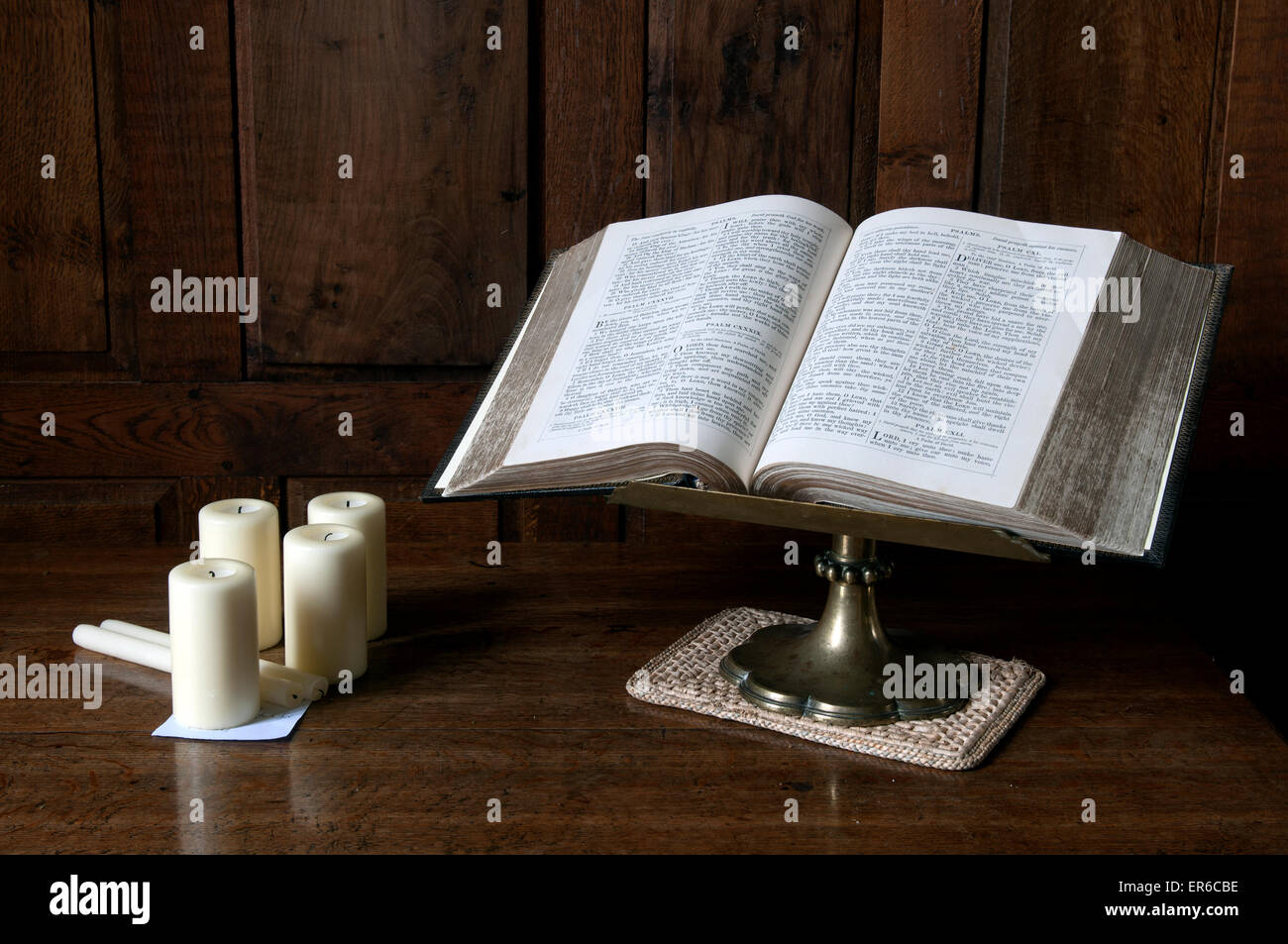 Bible and candles inside St. Peter and St. Paul Church, Courteenhall, Northamptonshire, England, UK Stock Photo