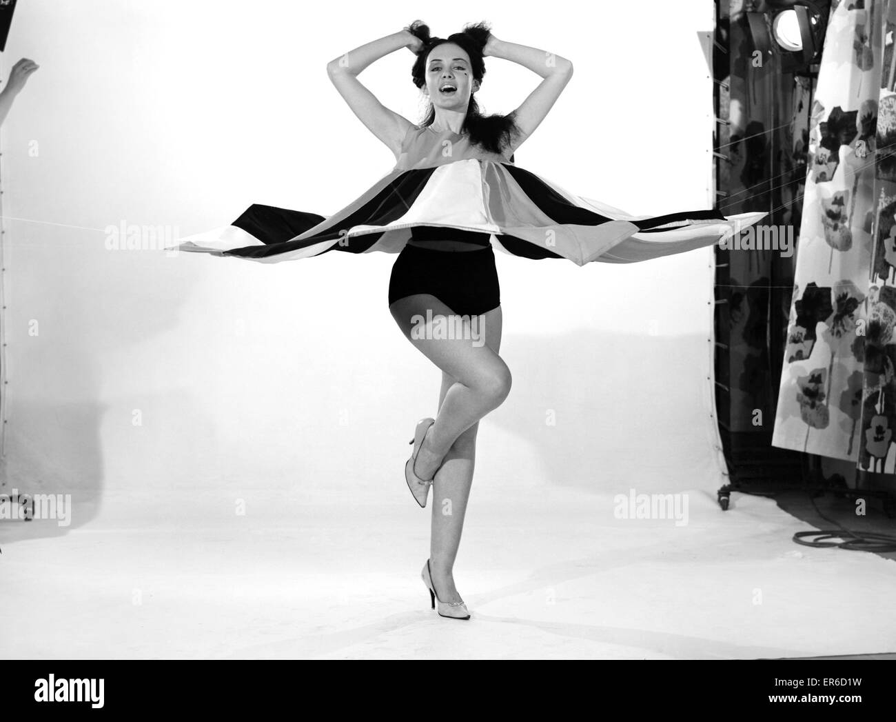 Clothing: Fashion: Dresses: Woman wearing umbrella dress. Model: Barbara Ernest. 1962 B1626-007 Stock Photo