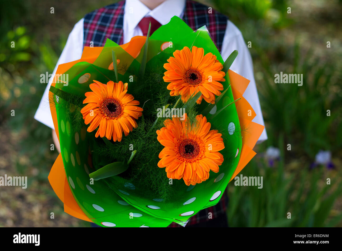 the school student with flowers, a close up Stock Photo