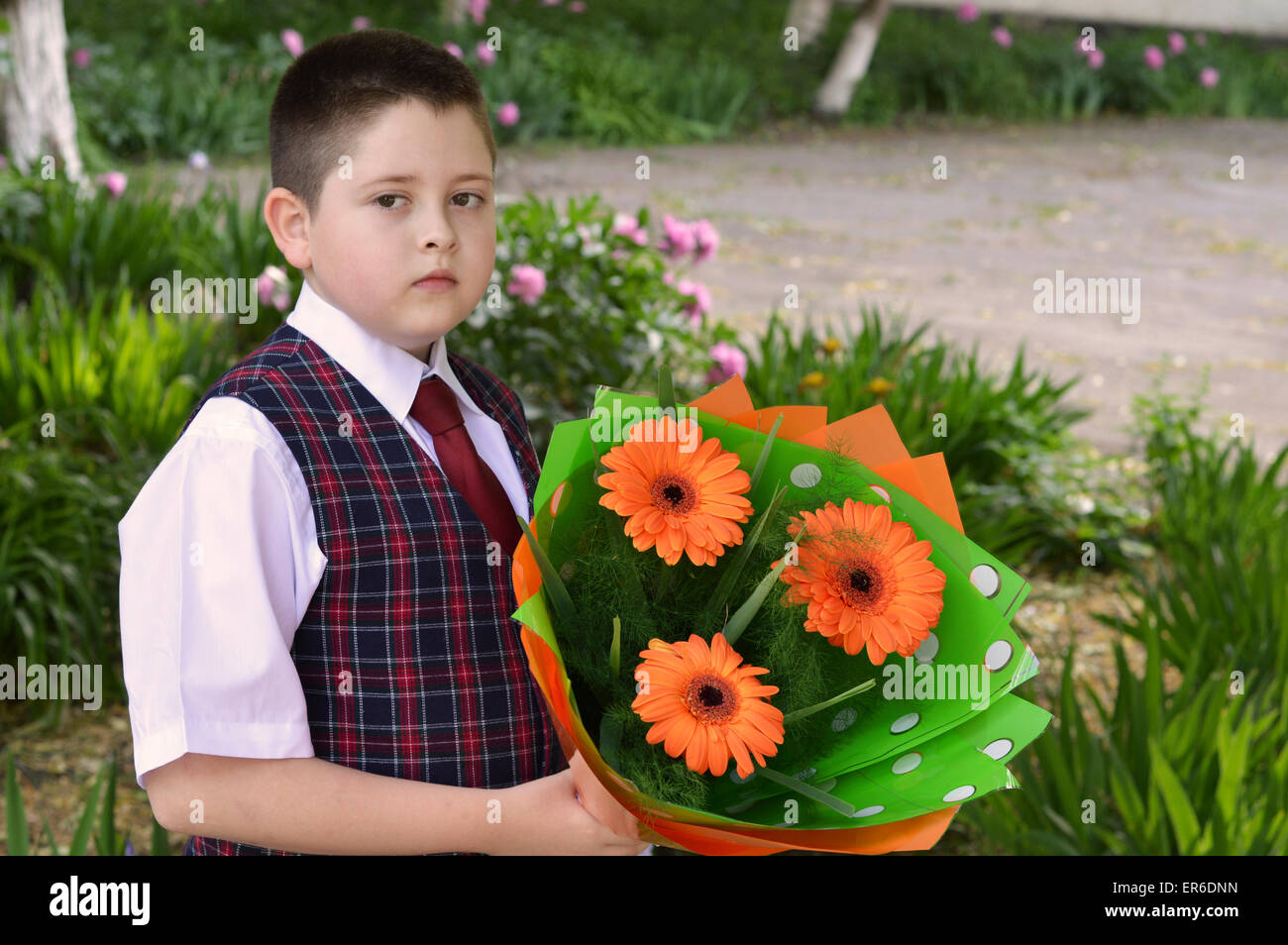 the boy with flowers goes to school, the last call Stock Photo