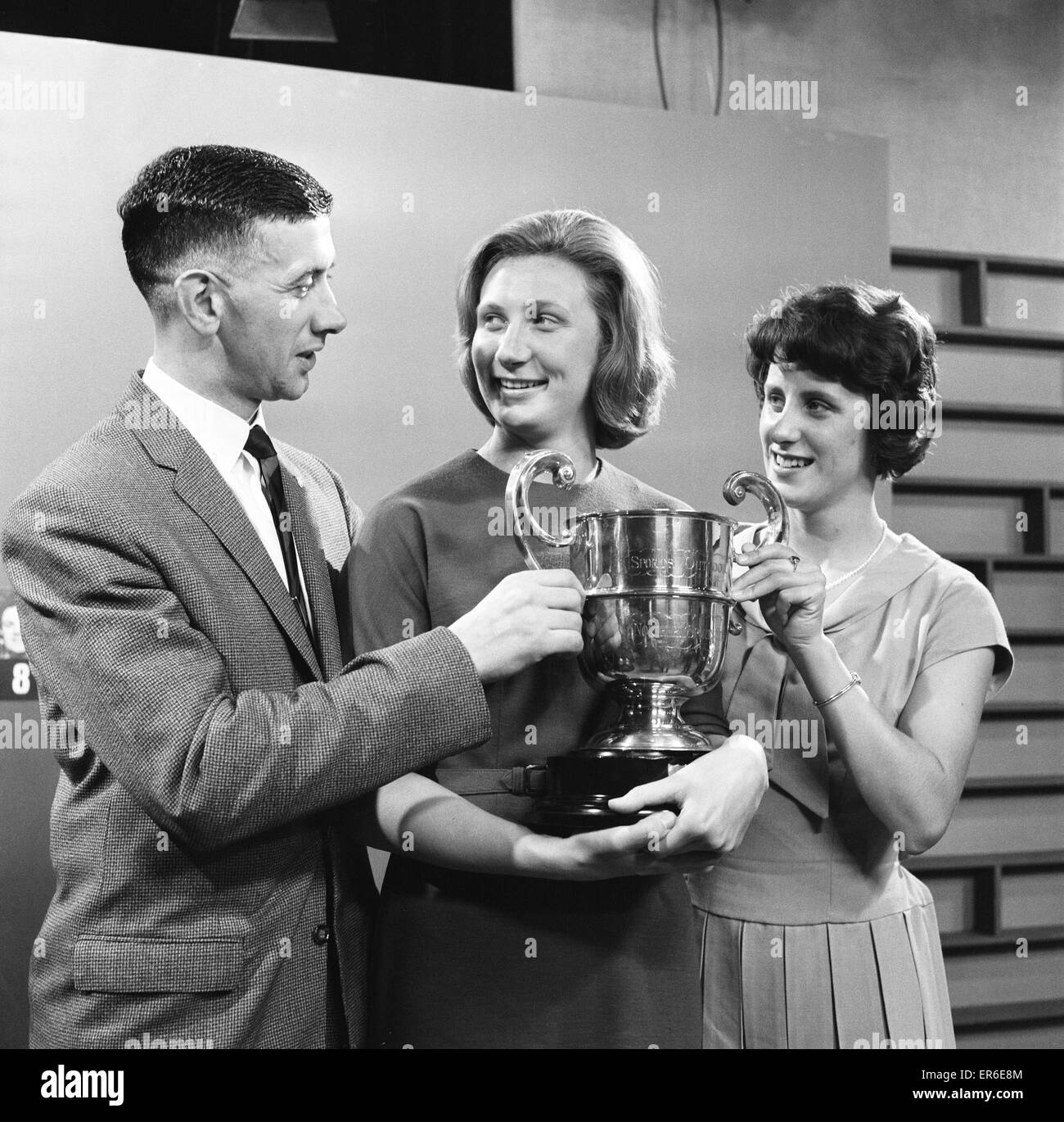 Anita Lonsbrough, swimmer from Great Britain who won a gold medal at the 1960 Summer Olympics, pictured after receiving Granada TV's Northern Sporting Personality of the Year Cup, 23rd December 1962. Also pictured, Burnley Skipper Jimmy Adamson (left) and Stock Photo