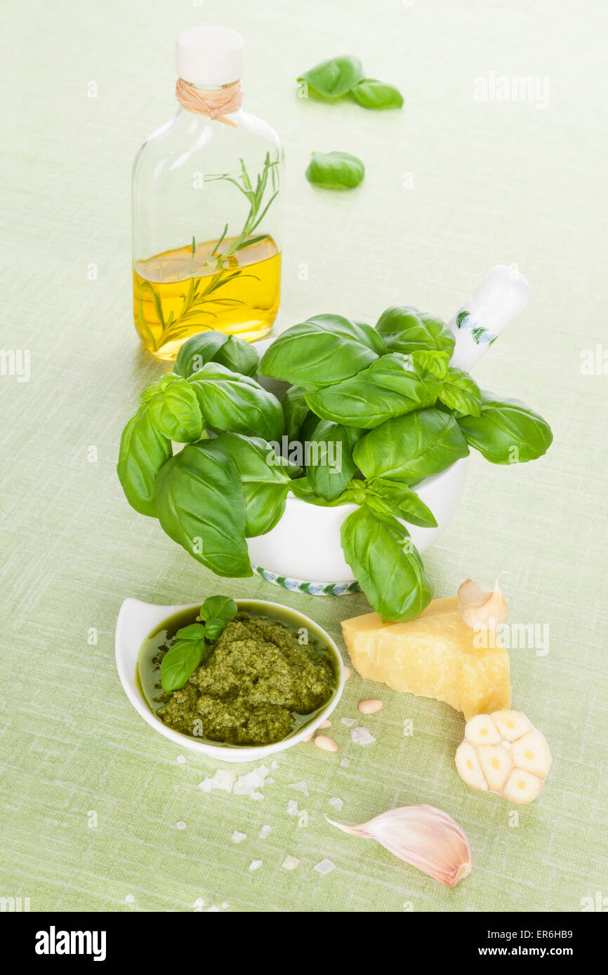Green pesto background. Extra virgin olive oil, green pesto, parmigiano