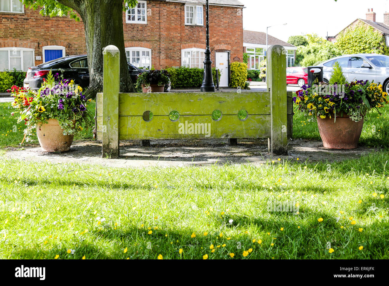 The stocks on the village green in an English rural community Stock Photo