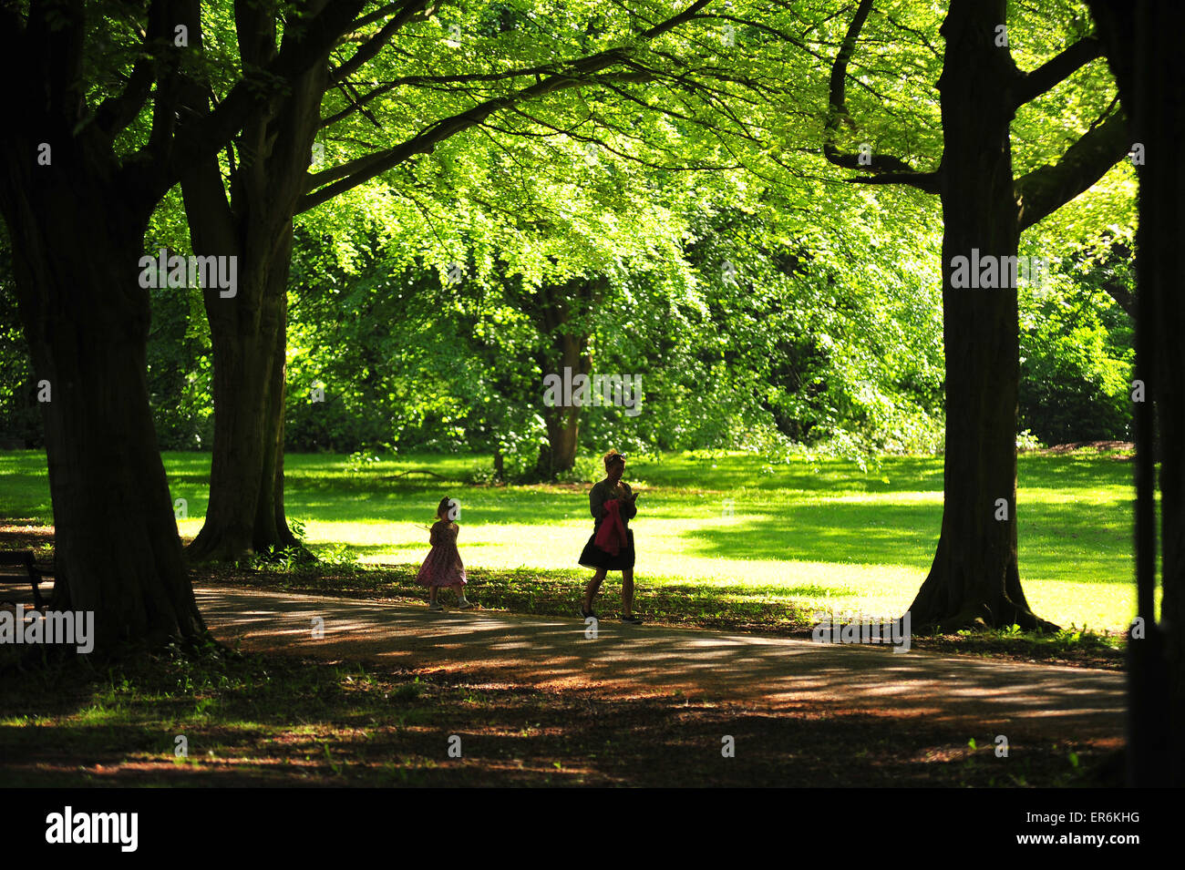 A mother and daughter walking along a tree lined path in the Clifton