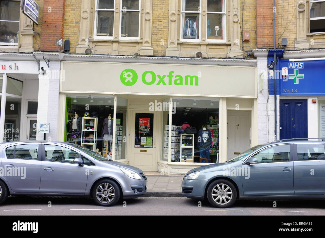 Cars parked in front of an Oxfam charity shop in the Clifton area of