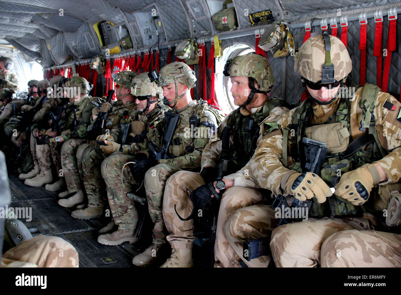 US, Czech, and Georgian soldiers sit inside a CH-47 Chinook helicopter before conducting a security patrol May 8, 2015 in Parwan province, Afghanistan. Stock Photo