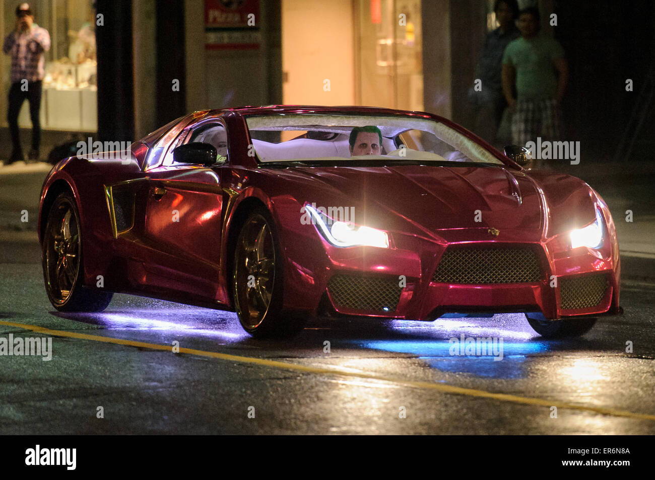 Toronto, Canada. 27th May, 2015. Stunt doubles for Jared Leto's Joker and Margot Robbie's Harley Quinn can be seen in a Vaydor G35 sports car on the movie set for action movie: Suicide Squad in Toronto, Ontario on May 27, 2015. Credit:  Julian Avram/Alamy Live News Stock Photo