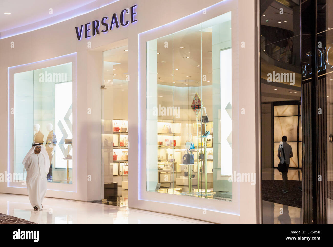 Arab shopper outside Versace Shop Dubai Mall Dubai City United Arab Emirates UAE Middle east Stock Photo