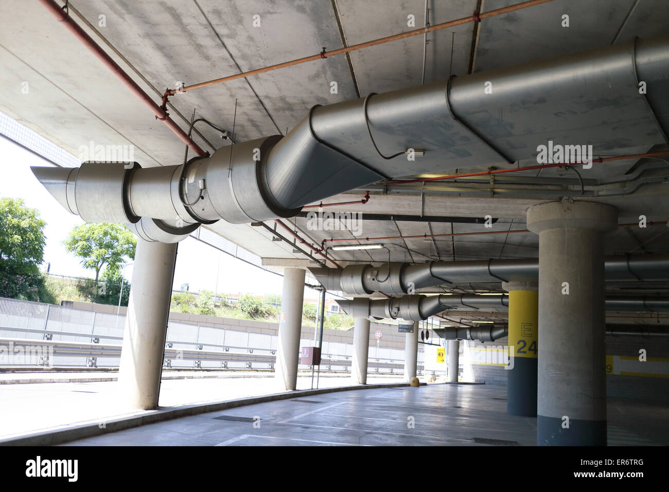 Underground park of a mall with columns and ventilation ducts Stock Photo