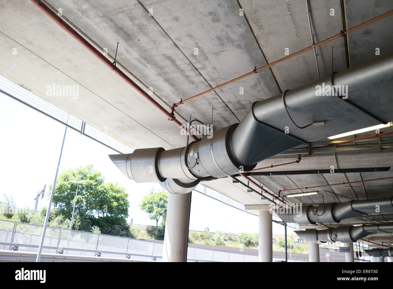 Underground park of a mall with columns and ventilation ducts Stock Photo