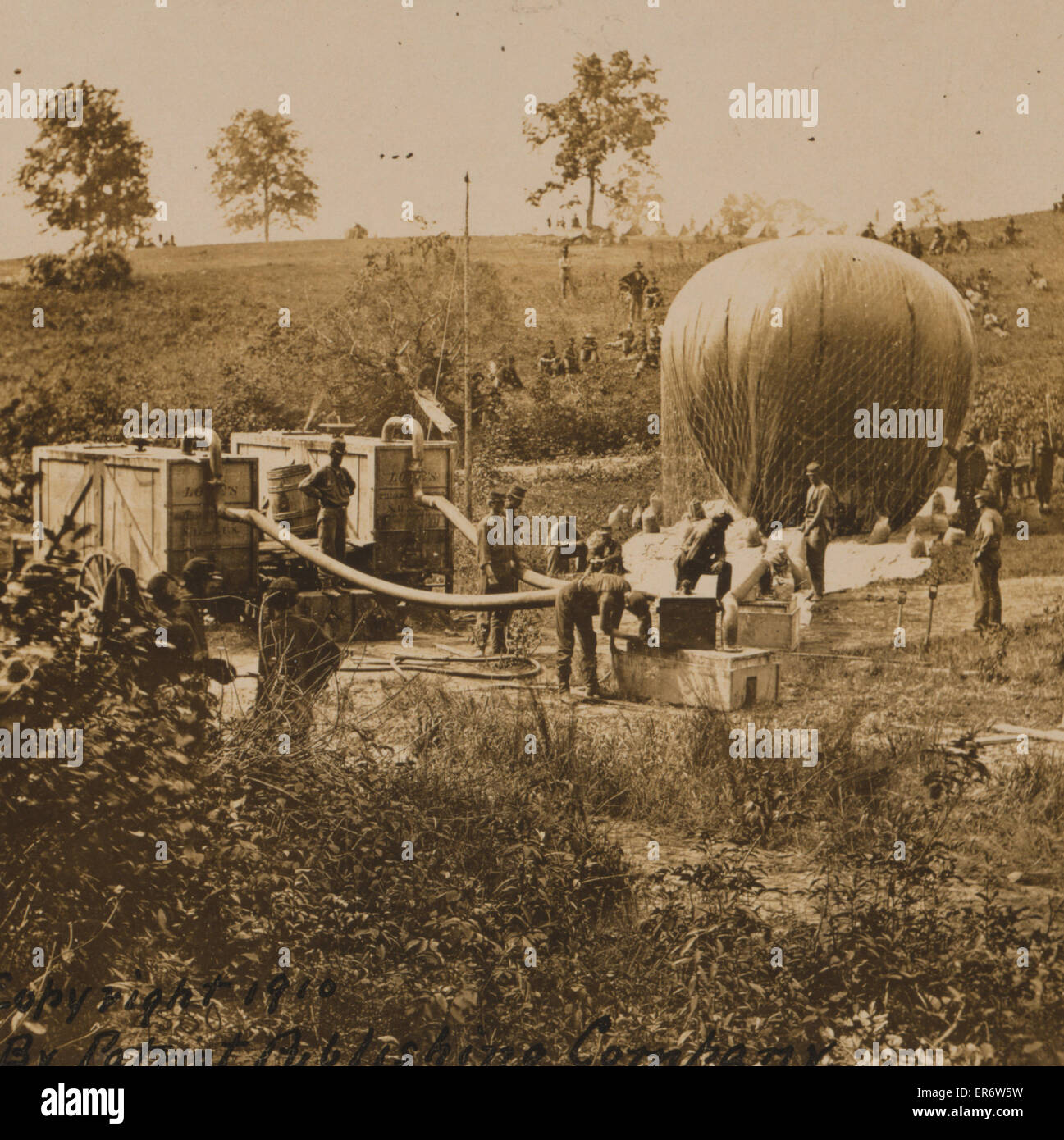 Professor Lowe's military balloon near Gaines Mill, Virginia. Professor Lowe standing to the right of balloon as it is being inflated. Date c1910. Stock Photo