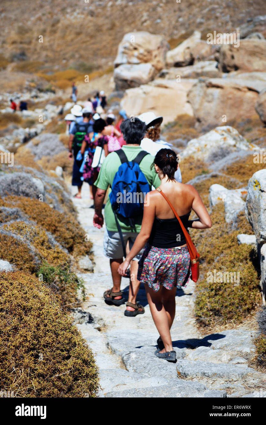 Tourists descending steps from the top of the hill on the archaeological island of Delos, Mykonos, Greece. Stock Photo
