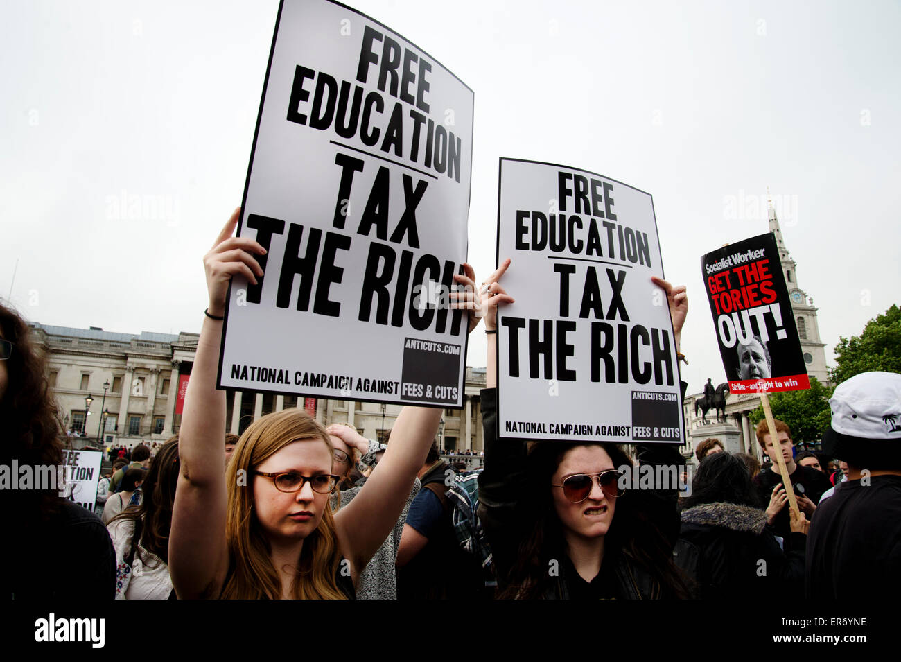 London Anti Austerity Protest. Two women protesters hold  placards saying 'Free education : Tax the Rich'. Stock Photo