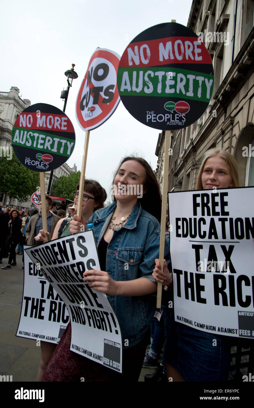 London Anti Austerity Protest. Whitehall. Young women UCL students hold placards saying 'No more austerity, Free education, tax Stock Photo