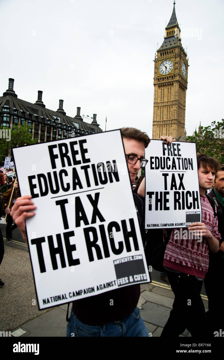 London Anti Austerity Protest. Protesters walk in front of Big Ben holding placards saying 'Free education, tax the rich'. Stock Photo