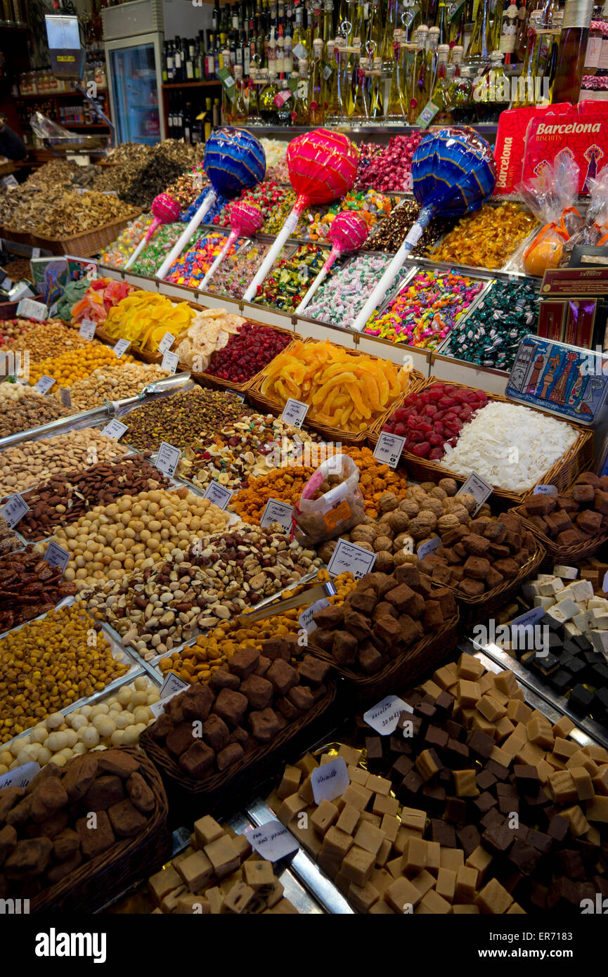 Candy, dried fruit and nuts on display at a vendor in a market at La Boqueria, Barcelona, Spain Stock Photo
