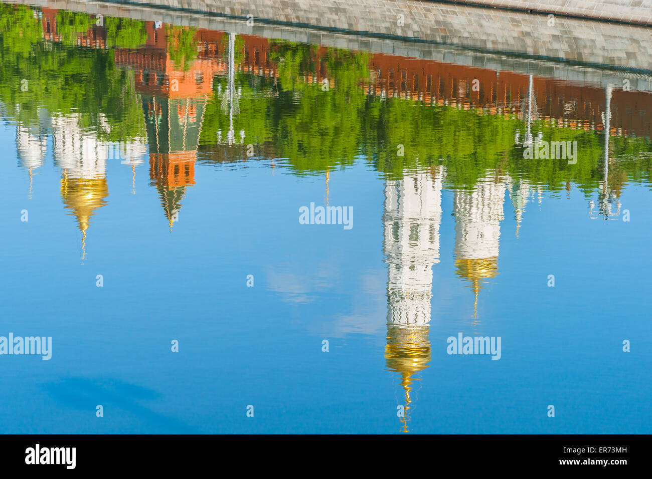 Reflection of the Kremlin cathedrals in calm water of the Moscow river early in the spring morning. Stock Photo