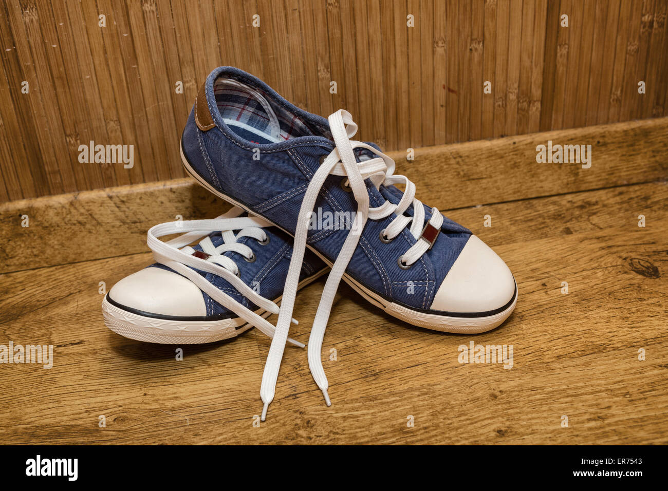 Canvas sneakers blue on the old wooden floor Stock Photo - Alamy