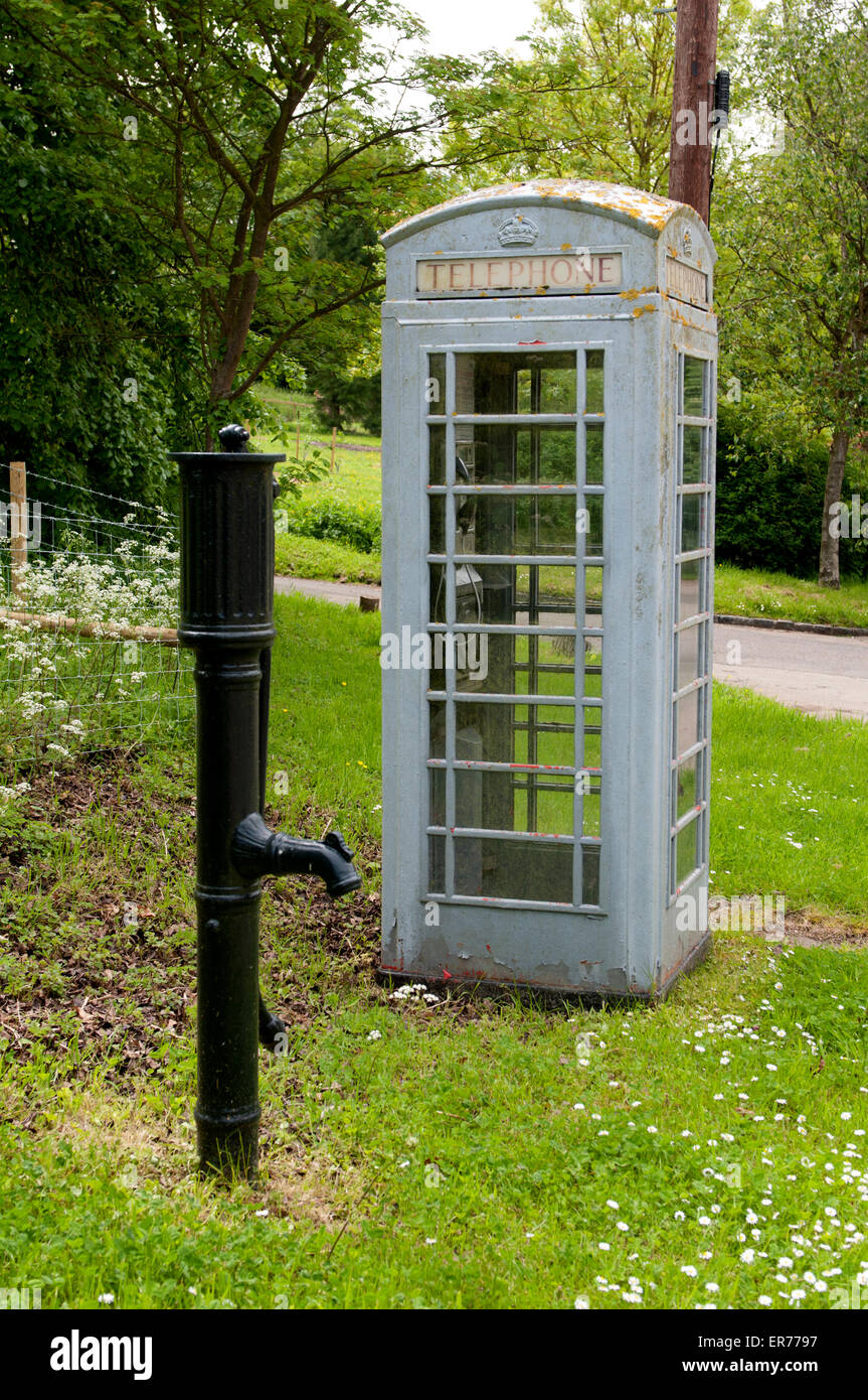 Pump and telephone box in Courteenhall village, Northamptonshire, England, UK Stock Photo