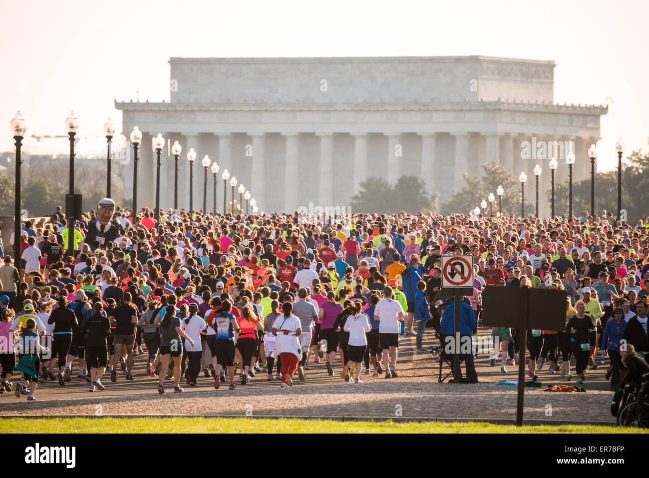 WASHINGTON DC, United States — Runners compete in the annual Cherry Blossom Ten Mile Run as they cross the Arlington Memorial Bridge with the Lincoln Memorial visible in the background. The springtime race, which coincides with the National Cherry Blossom Festival, attracts thousands of participants to the nation's capital. Stock Photo