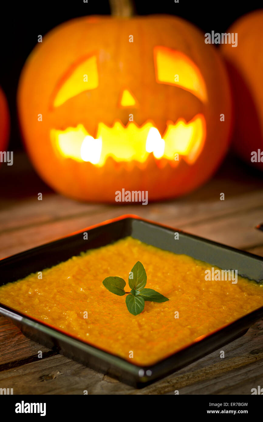 Pumpkin puree on wooden background Stock Photo