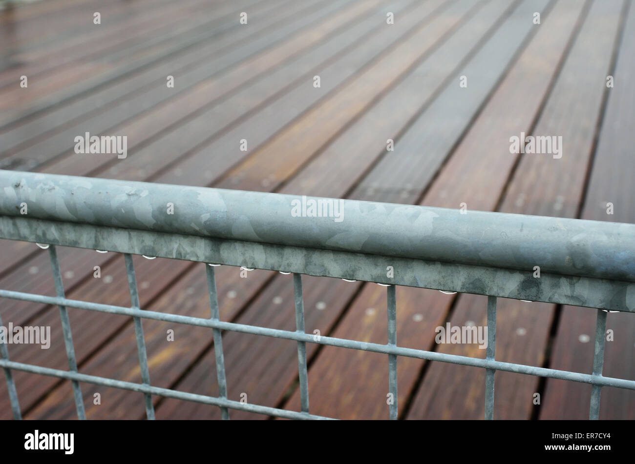 Wet railing of the wooden footway Stock Photo - Alamy