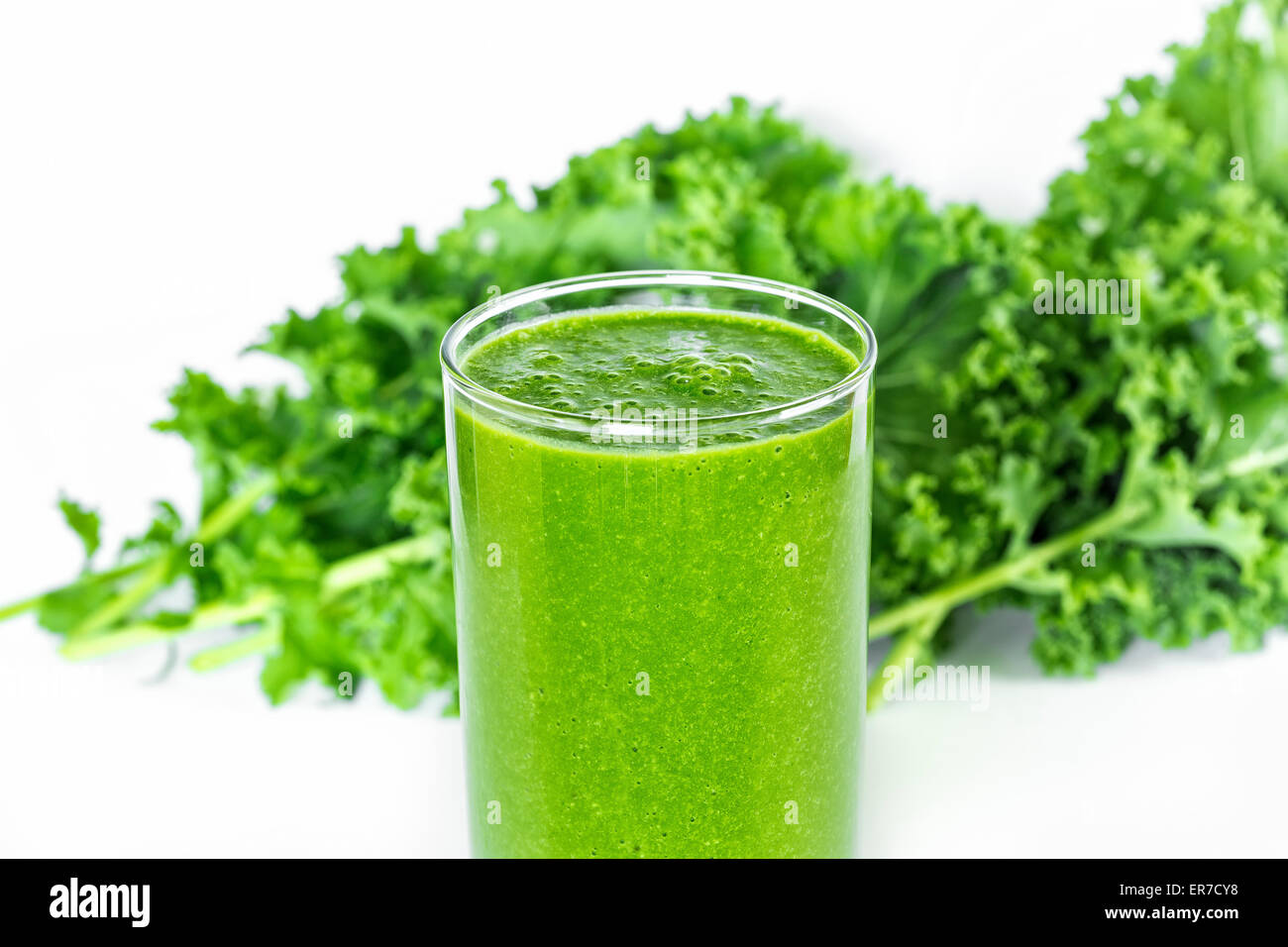 Green smoothie with kale in background. Stock Photo