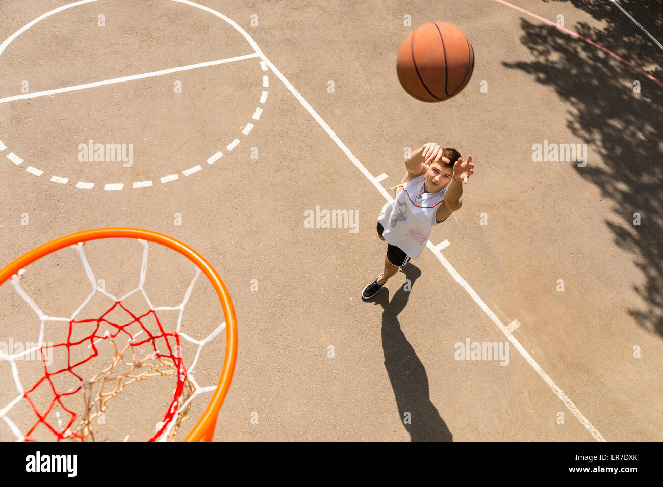 High Angle View of Young Man Playing Basketball, View from Above Hoop of Man Shooting Basketball Stock Photo
