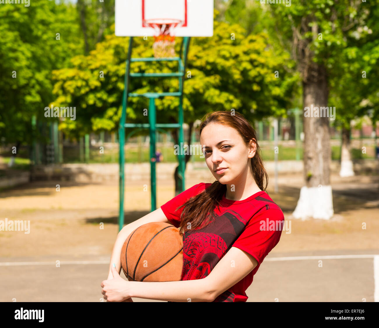 Competitive Looking Young Athletic Woman Standing on Basketball Court