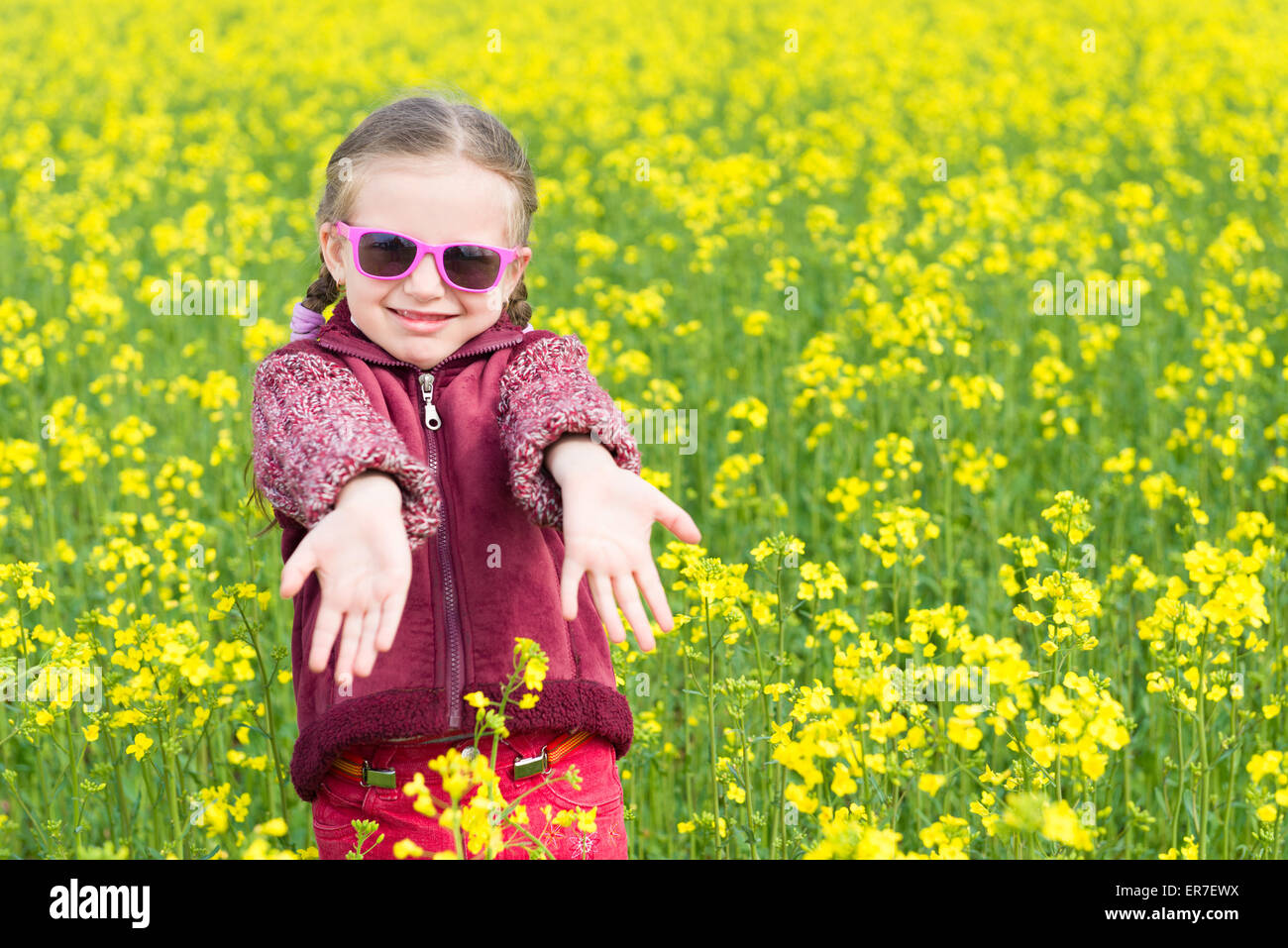 girl in a yellow field of rape Stock Photo - Alamy