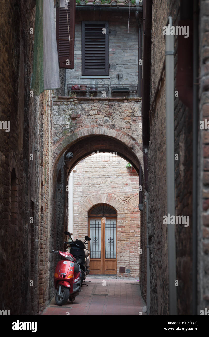 Vespa in alleyway in San Gimignano, Italy Stock Photo Alamy