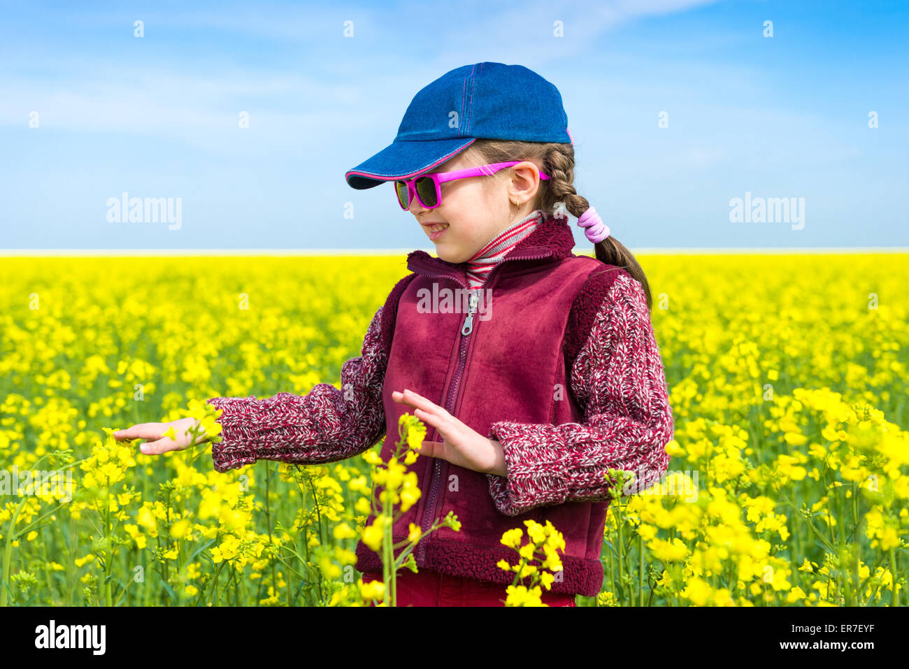 girl in a yellow field of rape Stock Photo - Alamy